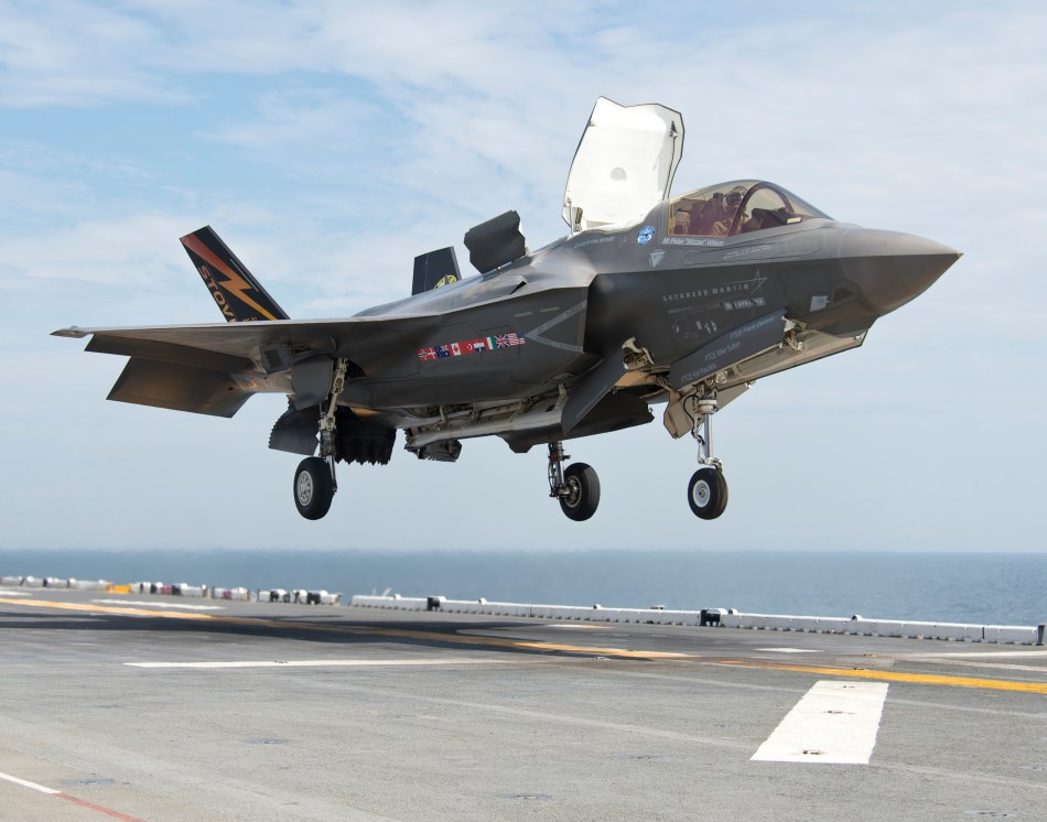 130814-O-ZZ999-280 ATLANTIC OCEAN (Aug. 14, 2013) An F-35B Lightning II aircraft lands aboard the amphibious assault ship USS Wasp (LHD 1) during the second at-sea F-35 developmental test event. The F-35B is the Marine Corps variant of the Joint Strike Fighter and is undergoing testing aboard Wasp. (U.S. Navy photo courtesy of Lockheed Martin by Andy Wolfe/Released)/Released)