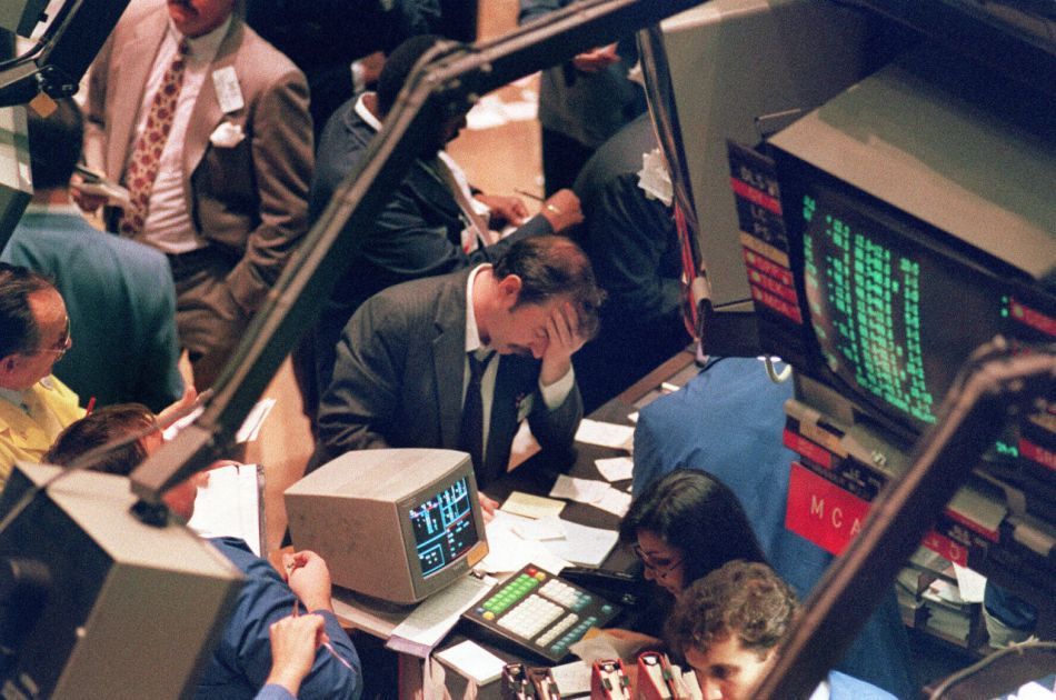 FILES - Picture taken 19 October 1987 shows a trader holding his head at the floor of the New York Stock Exchange when the Dow Jones dropped over 500 points, the largest decline in modern time, as panic selling swept Wall Street. The 19 October 2007 marks the 20th anniversary of the so-called "Black Monday", when the Dow Jones Industrial Average stock barometer plunged a dramatic 22.61 percent to 1,738.41 points. AFP PHOTO MARIA BASTONE (Photo credit should read MARIA BASTONE/AFP/Getty Images)